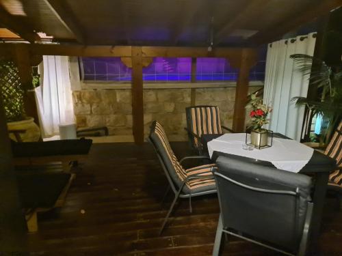 a table and chairs in a room with purple lights at Rosh Pinat Noy in Rosh Pinna
