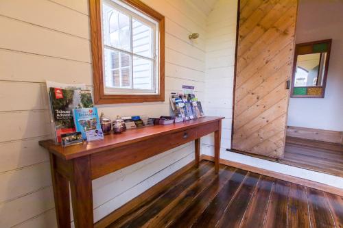 a room with a wooden counter and a window at Abbey on Main - Unique heritage listed property overlooking the Huon River in Franklin