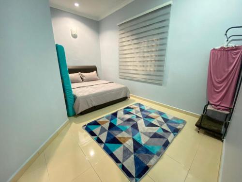 a bedroom with a bed and a rug on the floor at My Pool House in Alor Setar