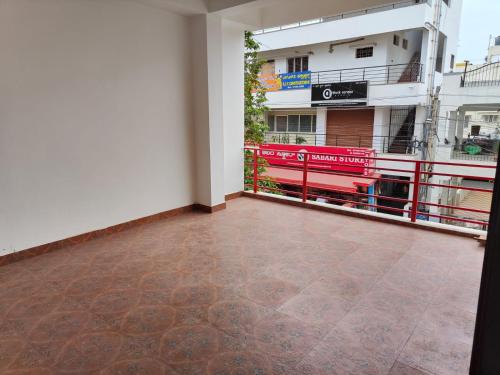 a room with a tile floor and a building at Navilu Homes in Mysore