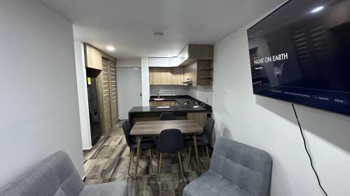 a kitchen with a table and chairs in a room at 026 Hills in Dosquebradas