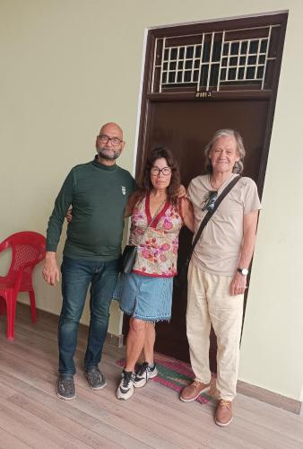 a group of three people standing in front of a door at Foreigners Inn in Varanasi