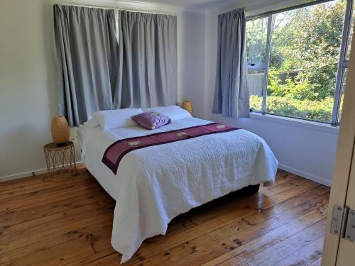 a bedroom with a bed and a large window at Richmond Central 3bdrm House sleeps 7 in Richmond