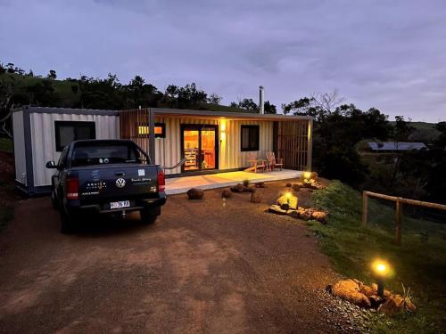 a truck parked in front of a tiny house at Aquila Eco Retreat in Richmond