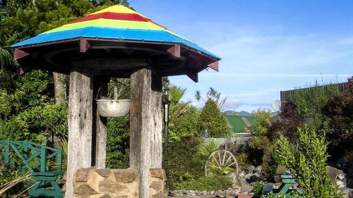 a colorful bird feeder with a umbrella on top of it at Westport Kiwi Holiday Park & Motels in Westport