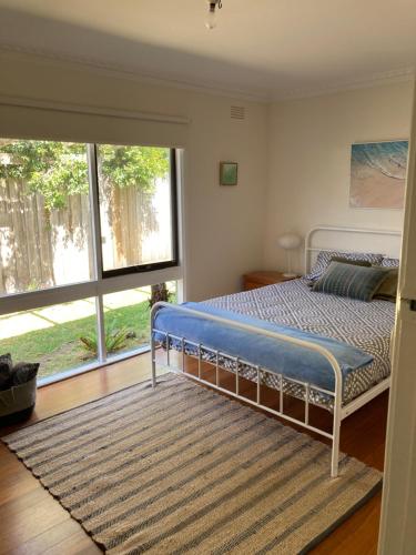 a bedroom with a bed and a large window at Classic Cowes in Cowes