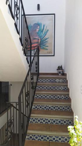a stairway with a painting on the wall at Hotel La Lejona in San Miguel de Allende