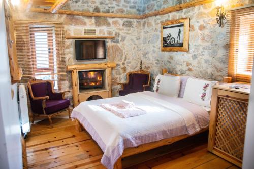 a bedroom with a bed and a fireplace at Mogla Tashan Hotel in Muğla