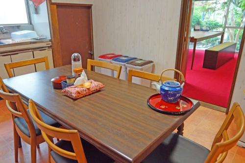 a wooden table in a kitchen with a dining room at 日本庭園古民家　飯田屋　Traditional experience iidayajapan in Yokohama