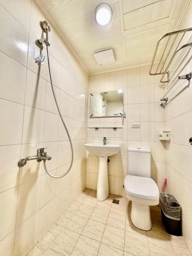 a bathroom with a shower and a toilet and a sink at 澄居 live in in Taichung