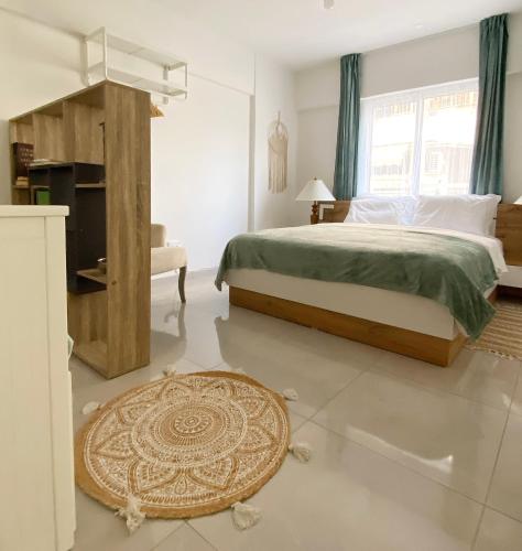 a bedroom with a large bed and a rug at Peaceful 2 bedroom Flat in İncirli