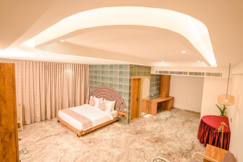 a bedroom with a bed in a room at Hotel Mirana , Tinsukia in Tinsukia