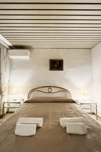 a bedroom with a bed with two white towels on it at Da Mario in Florence Guesthouse in Florence