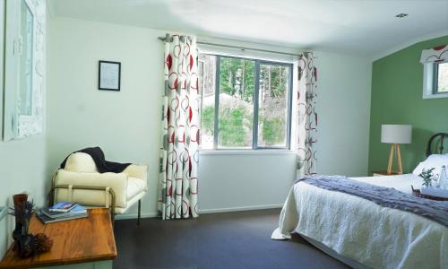 a bedroom with a bed and a window at Vines on Bannockburn in Cromwell