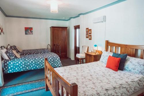 a bedroom with two beds and a bedskirts at Dingup House in Manjimup