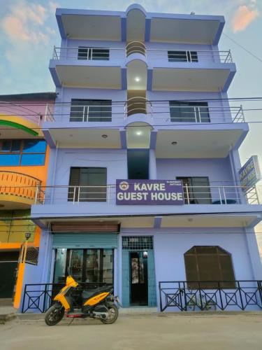 a motorcycle parked in front of a building at Kavre Guest House in Lumbini