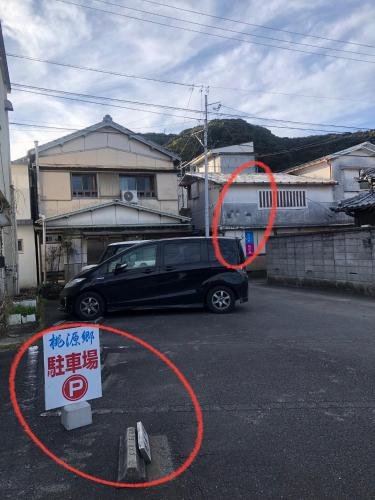 a car parked in a parking lot with a red circle at 桃源郷２ in Toba