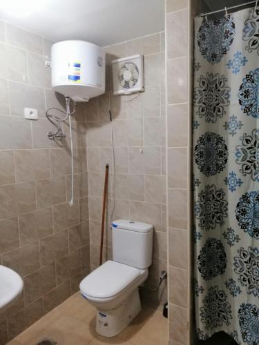 a small bathroom with a toilet and a sink at شالية بقرية بالميرا in Ain Sokhna