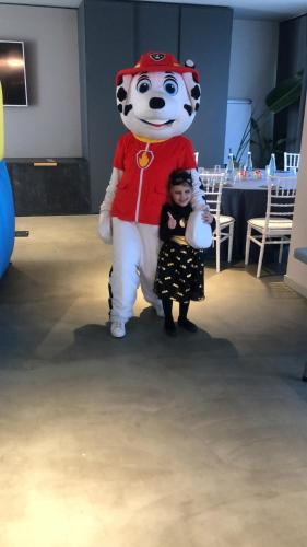 a little girl is standing next to a giant cat mascot at Modica Boutique Hotel in Modica