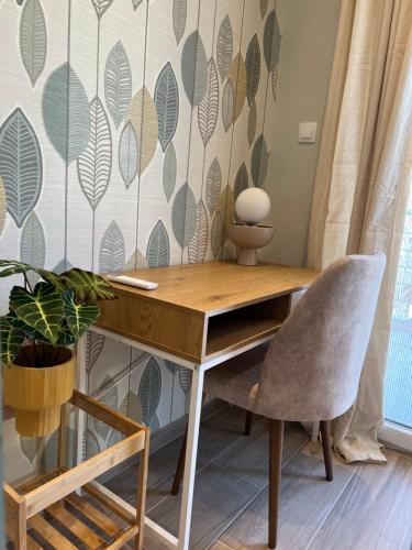 a desk and a chair in a room with a wall at CASA MILITOU-NEA FILADELFIA in Athens