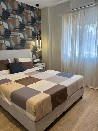 una camera da letto con un grande letto con una grande finestra di CASA MILITOU-NEA FILADELFIA ad Atene