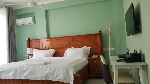 Ένα ή περισσότερα κρεβάτια σε δωμάτιο στο Eastern City Hotel