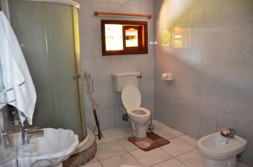 a bathroom with a toilet and a sink at Belle Amie Self Catering in La Digue