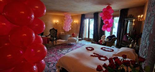 a bedroom with red and pink balloons and a bed at Faqra Palace in Kfardebian