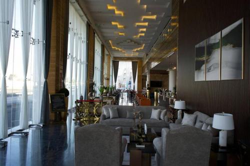 a lobby with couches and chairs in a building at Golden Dream Hotel in Khamis Mushayt