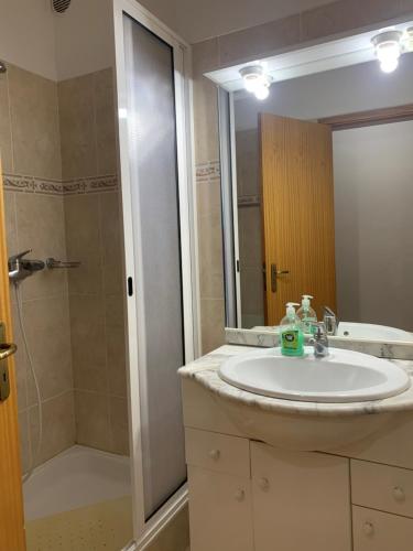a bathroom with a sink and a shower at Bento Lodge by Madeira Holiday Rentals in Ribeira Brava