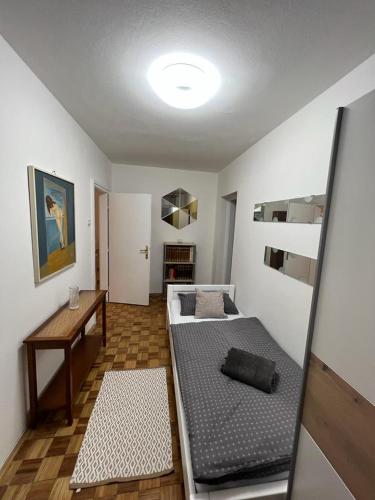 a room with two beds and a desk in it at Sweet apartman Maša in Zagreb