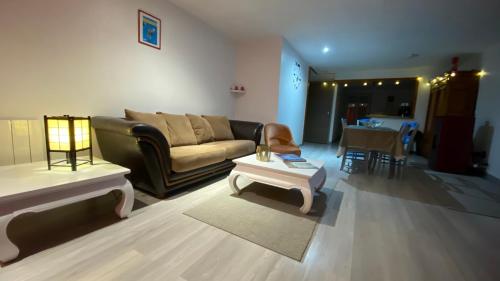 a living room with a couch and a table at Gîte dû Raddon in Raddon-et-Chapendu