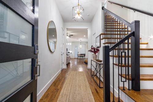 a hallway with a staircase and a mirror at Beautiful Contemporary 4BR near Downtown Dallas in Dallas