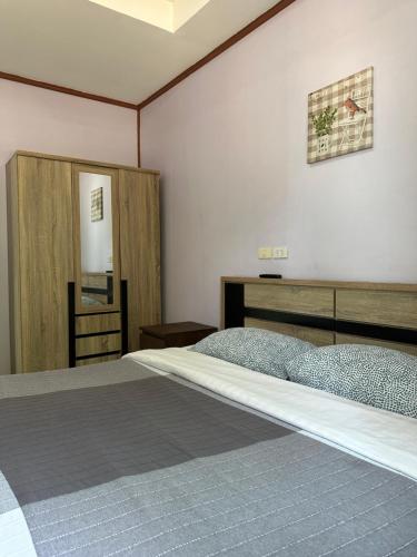 a bedroom with two beds and a mirror at Fine Times Resort in Ko Chang
