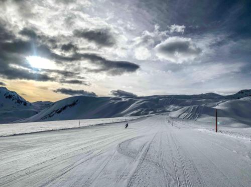 a person is skiing down a snow covered slope at Heimelige Ferienwohnung mit Sicht in die Bergwelt in Bivio