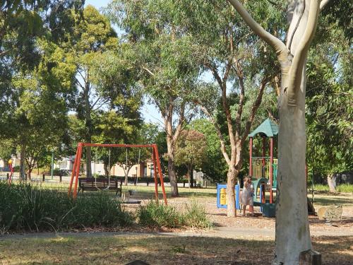 a park with a swing set and a playground at House on the Heights in Lyndhurst