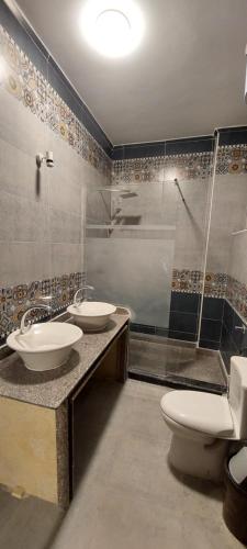 a bathroom with two sinks and a shower and a toilet at heart of town sea view in Safaga