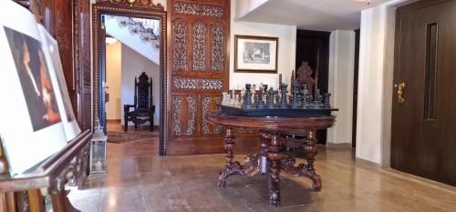 a room with a wooden table with a mirror at Faqra Palace in Kfardebian