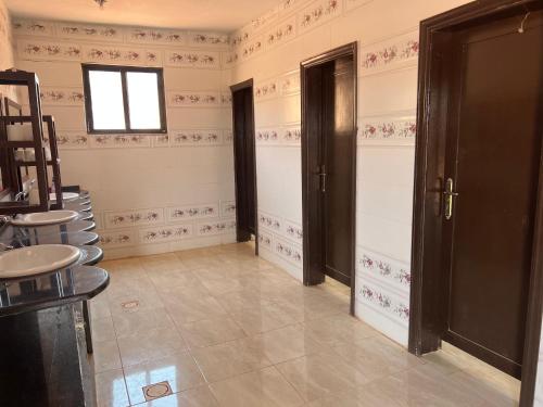 a room with two doors and a tile floor at Wadi Rum Desert Adventures in Wadi Rum
