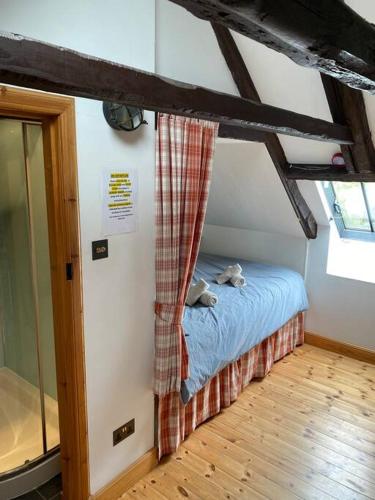 a bedroom with a bed with a curtain on it at Dunes View, Cottage1, Dunnetbay accommodation in Castletown