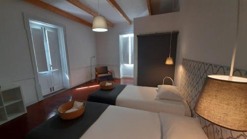 a hotel room with a bed and a chair at A Casa do Tenente in Faro