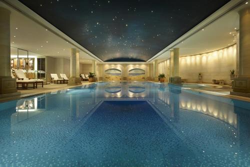a large swimming pool in a hotel with a star ceiling at The Langham Sydney in Sydney