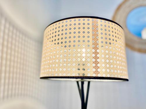 a lamp with a beige and black shade in a room at Brest - Le Gestin - Appartements - Lumineux - Tout Confort - Fibre Internet in Brest