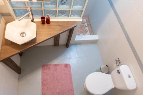 a bathroom with a sink and a toilet at City Life Timisoara in Timişoara