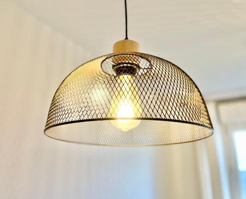 a metal lamp hanging from a ceiling at Brest - Le Gestin - Appartements - Lumineux - Tout Confort - Fibre Internet in Brest