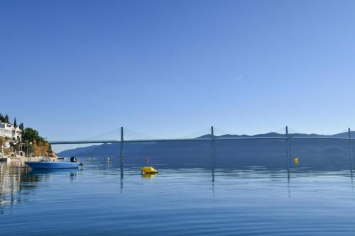 a large body of water with a boat in it at Apartments Boženka in Klek