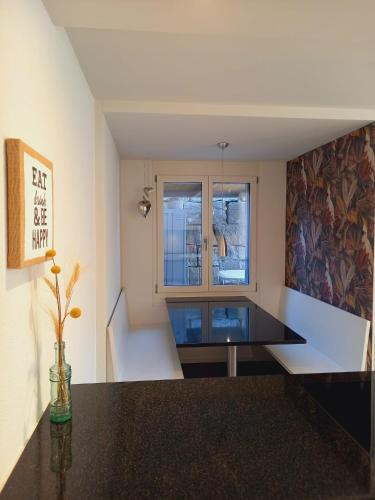 a kitchen with a black counter top and a window at Neue Wohnung an Stadtrand mit Parkplatz in Ebikon