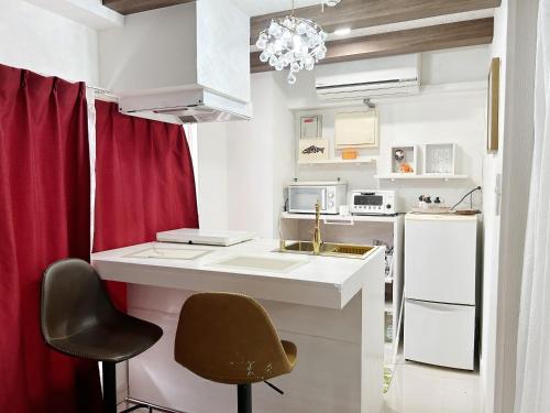 a kitchen with a sink and a counter with a chair at Ocean Villa Tin Gala in Onna