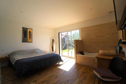 une chambre avec un lit et une salle de bain avec baignoire dans l'établissement Superbe villa idéale pour la détente !, à Saint-Vincent-de-Tyrosse