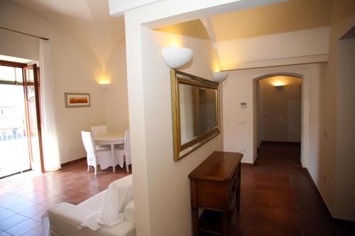 a living room with a white couch and a table at Palazzo Iaquinto in Santa Maria di Castellabate